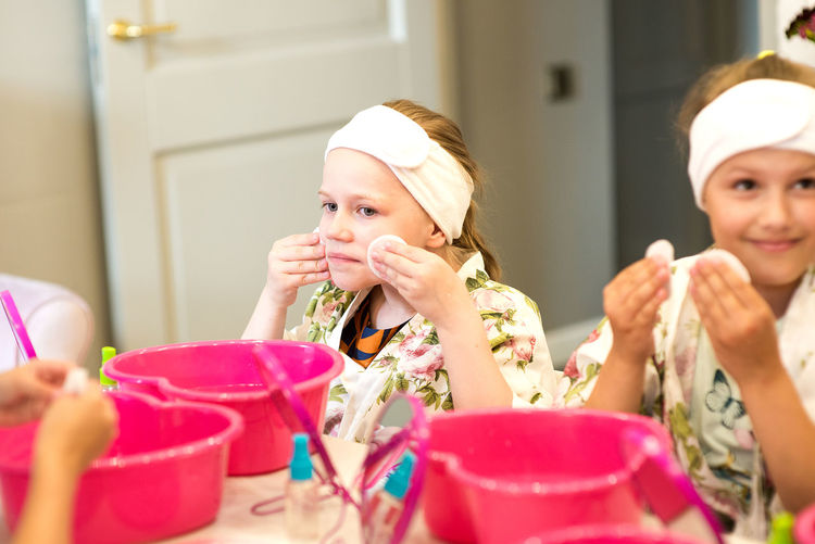 Close-up of girls wiping face