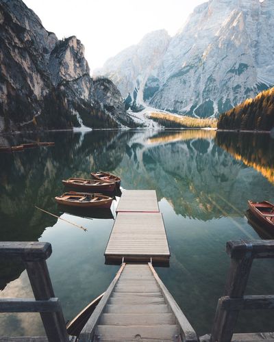 Pier over lake against mountains