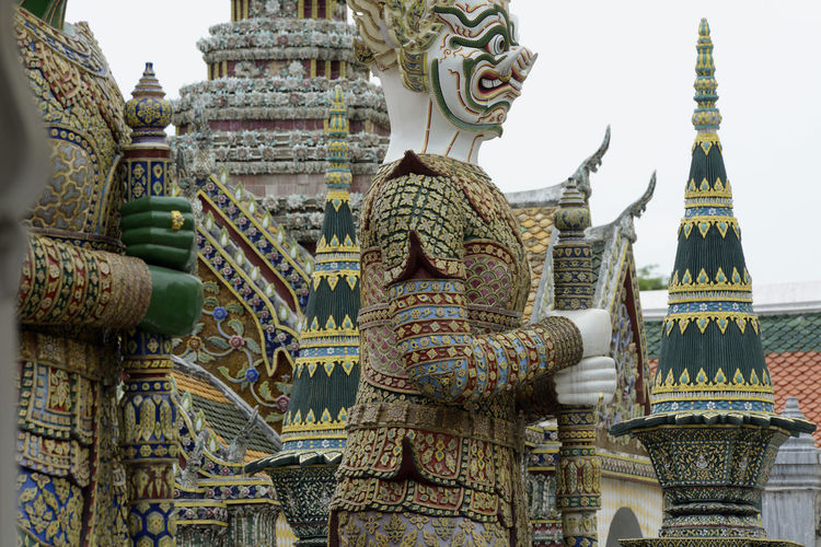 Low angle view of guardian statues at wat phra kaeo