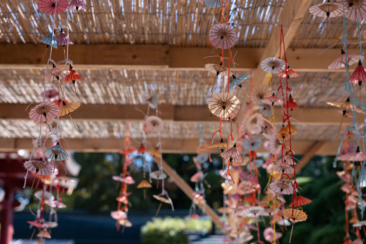 Many small umbrellas hanging in the shrine