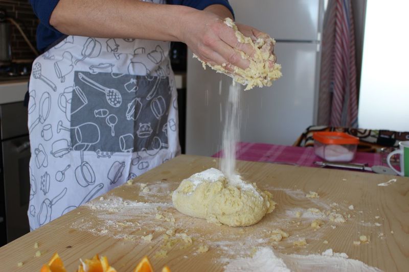 Midsection of person preparing dough