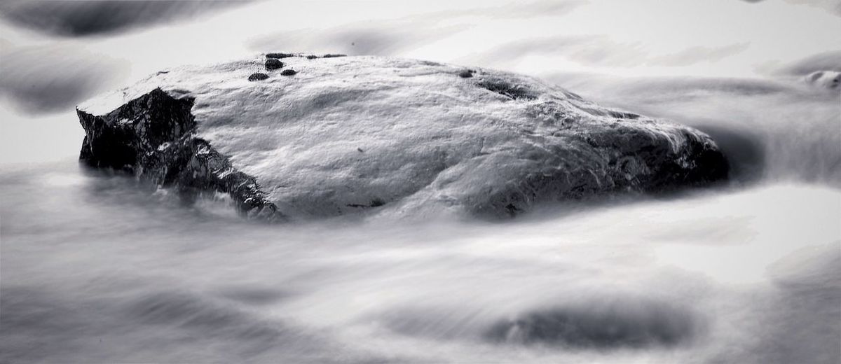 Snow covered landscape against cloudscape