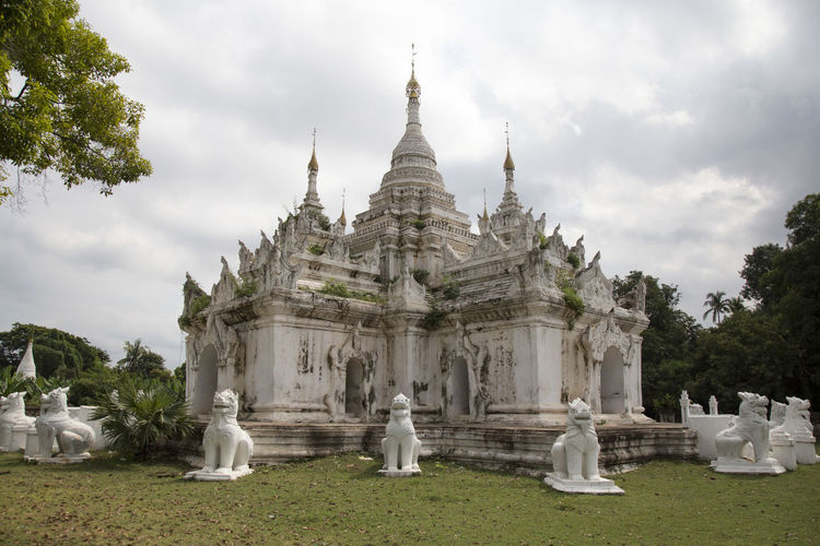 White old temple surrounded by lion statues at burmese pagoda