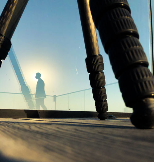 Low angle view of man standing against railing