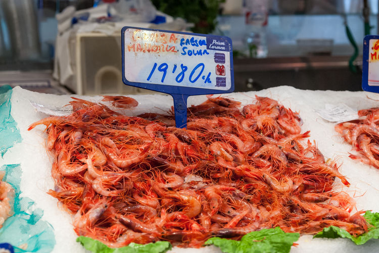 Fresh shrimps with price tag at market