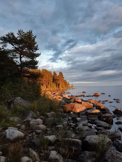 Rock formations by sea against sky