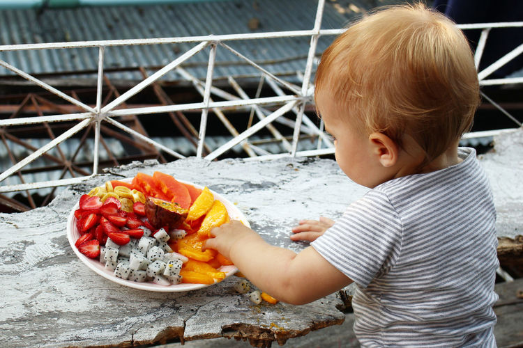 Baby girl having fruits