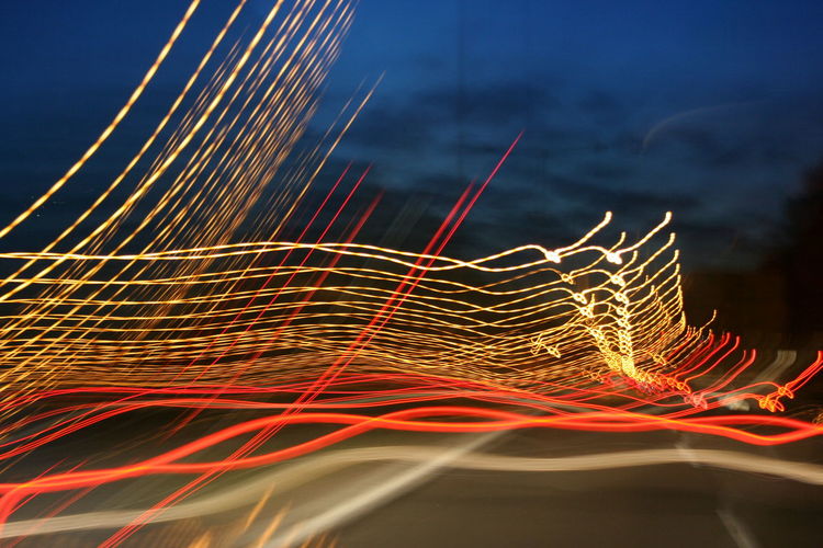 Close-up of light trails against sky at night