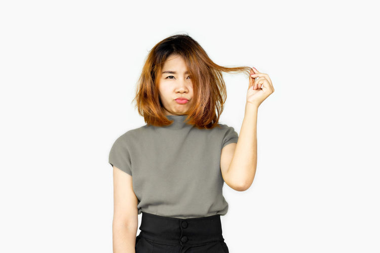 Portrait of a girl standing against white background