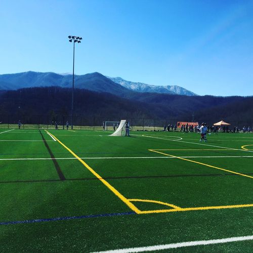 Lacrosse field against mountains on sunny day