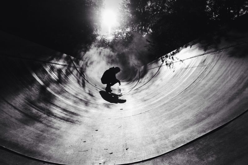 Man crouching on skateboard