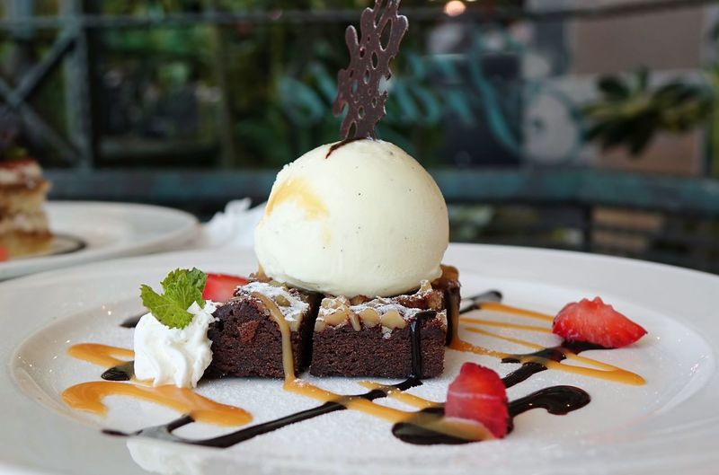 Chocolate brownie with ice cream in plate on restaurant table