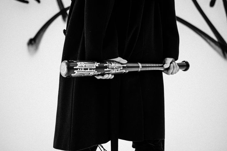 Close-up of person holding baseball bat