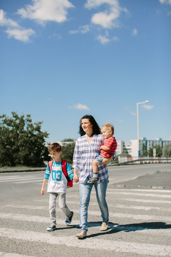 Mother and two children on zebra crossing