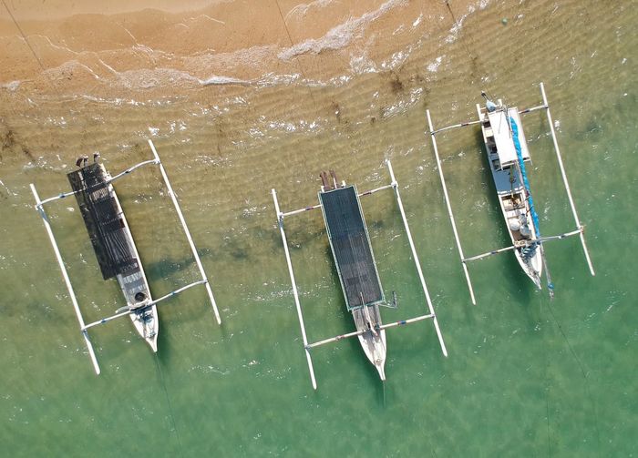 High angle view of outriggers in sea