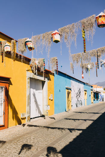 Street with multi-coloured houses decorated with piñatas in oaxaca, mexico