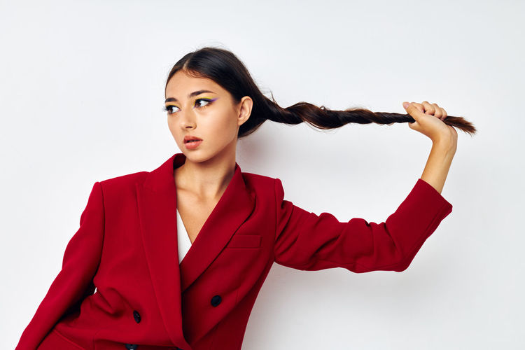 Young woman standing against white background