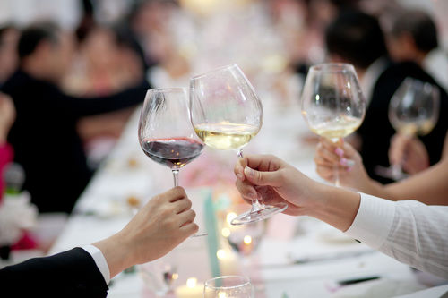 Cropped image of business people toasting wineglasses at dining table