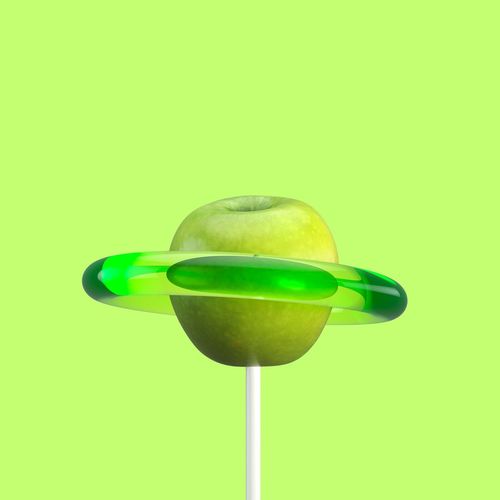 Close-up of apple candy against green background