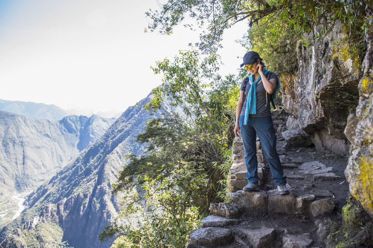 Woman looking down from inca trail path close to machu picchu,