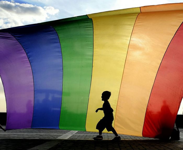 Full length of child against rainbow flag