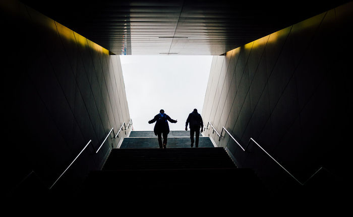 Low angle view of men walking on steps