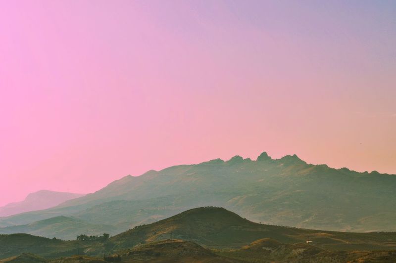 Scenic view of mountains against sky during sunset
