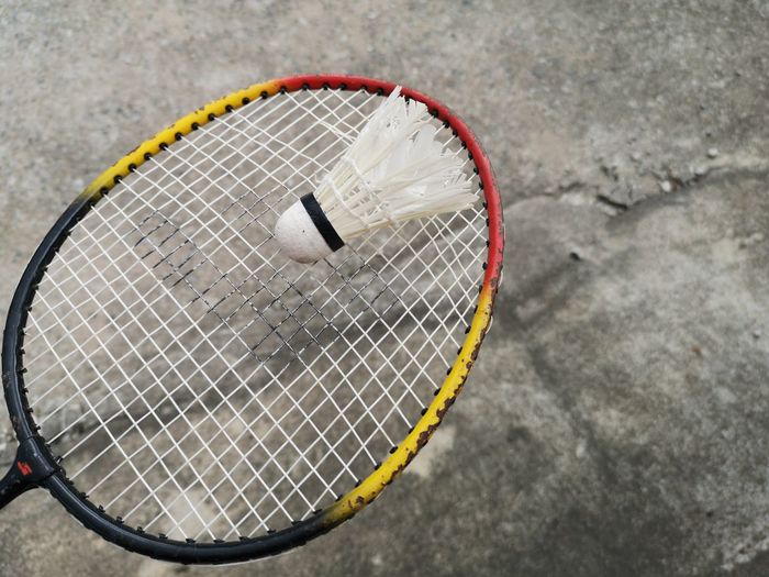 High angle view of shuttlecock on tennis racket