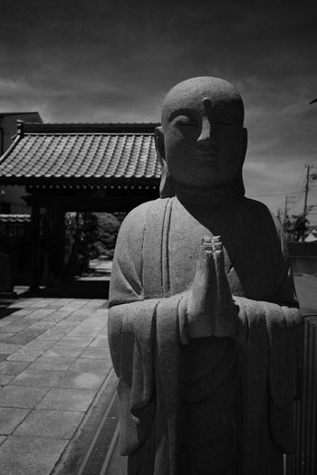 Statue of buddha against building