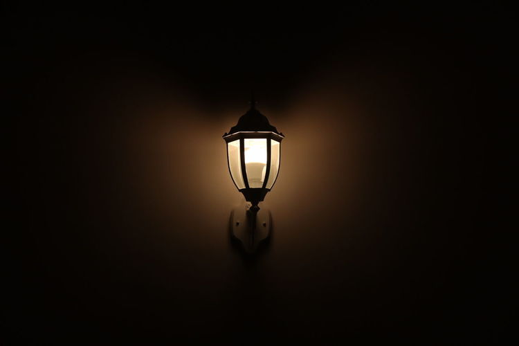 Close-up of illuminated light bulb in darkroom