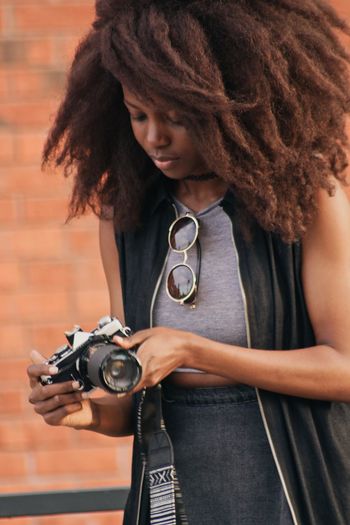 Close-up of woman holding camera