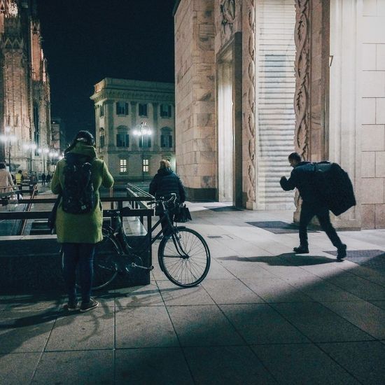 Woman walking in city at night