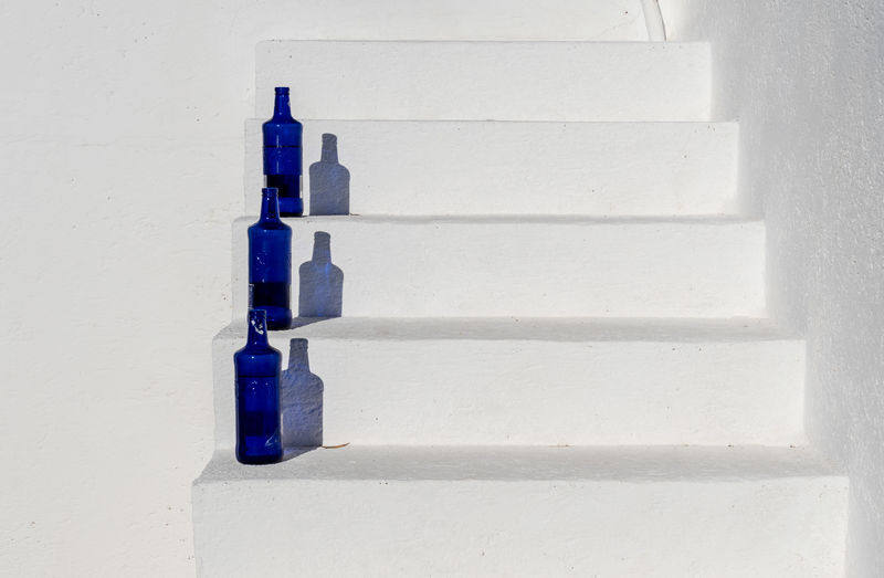 Close-up of bottles on steps