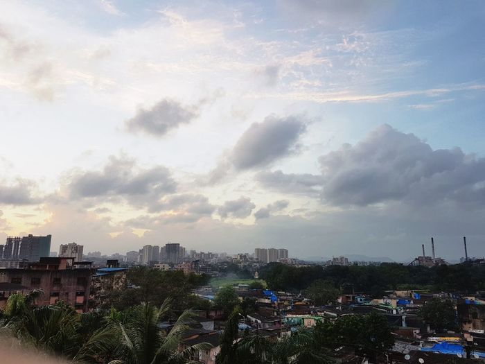 High angle view of cityscape against cloudy sky