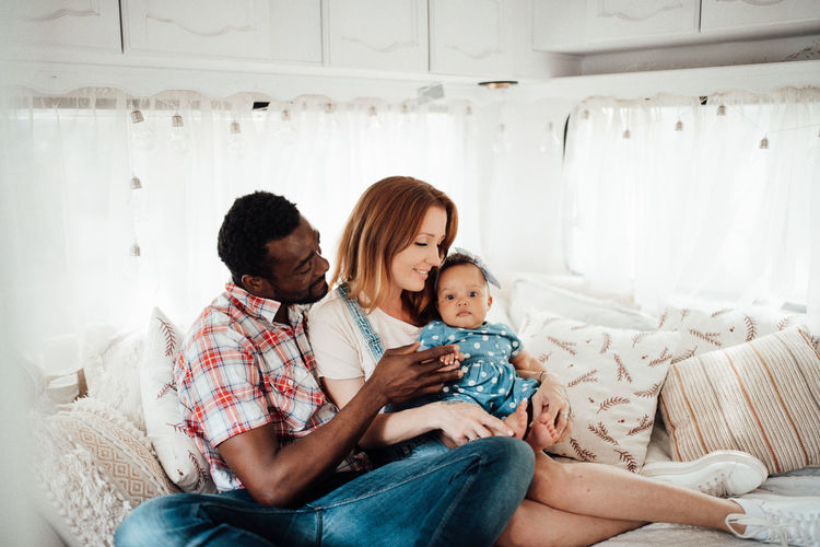 Cheerful family siting in camper van