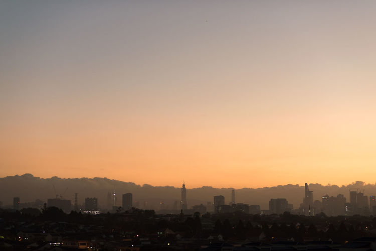 Scenic view of kuala lumpur city horizon at dawn with low clouds