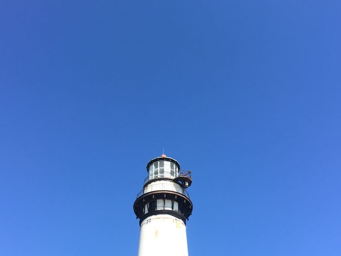 Low angle view of lighthouse against clear blue sky