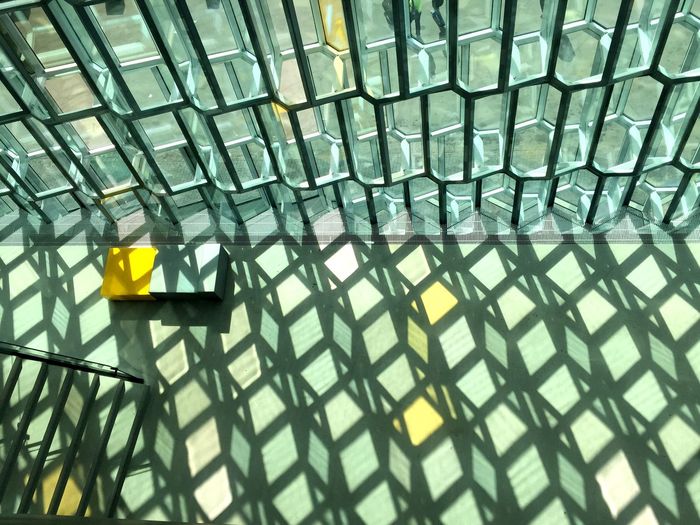 High angle view of shadow of glass window on floor at lobby
