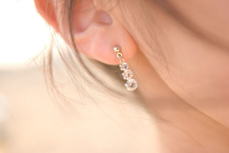 Cropped image of woman wearing earring