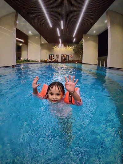 Portrait of woman swimming in pool
