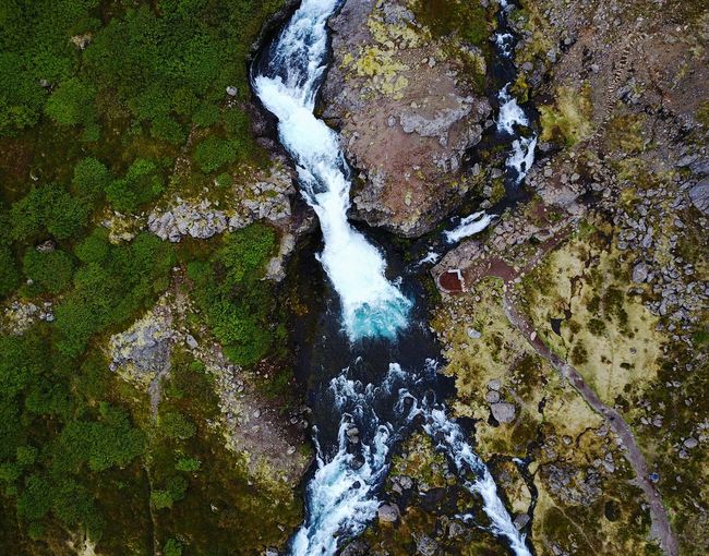 High angle view of waterfall amidst river