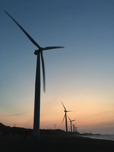 Low angle view of windmill against sky during sunset