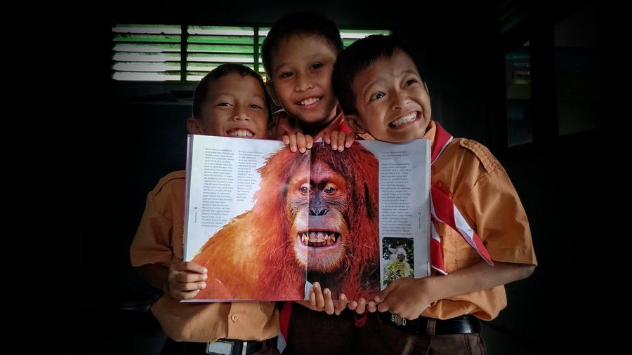 Indonesian elementary school children with an encyclopedia