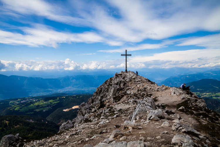 Panoramic view of cross on mountain against sky