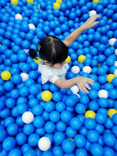High angle view of girl playing in ball pool