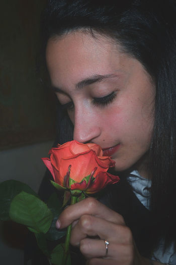 Close-up of woman with red rose