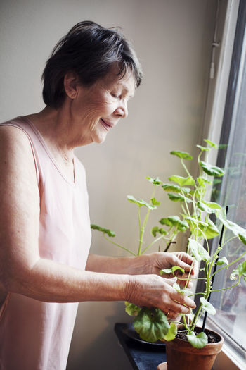 Senior woman looking at flowers