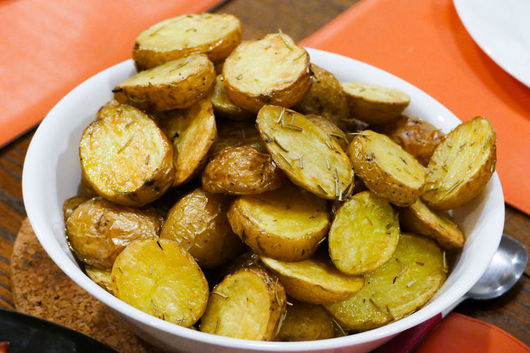 High angle view of roasted potatoes in a bowl on table