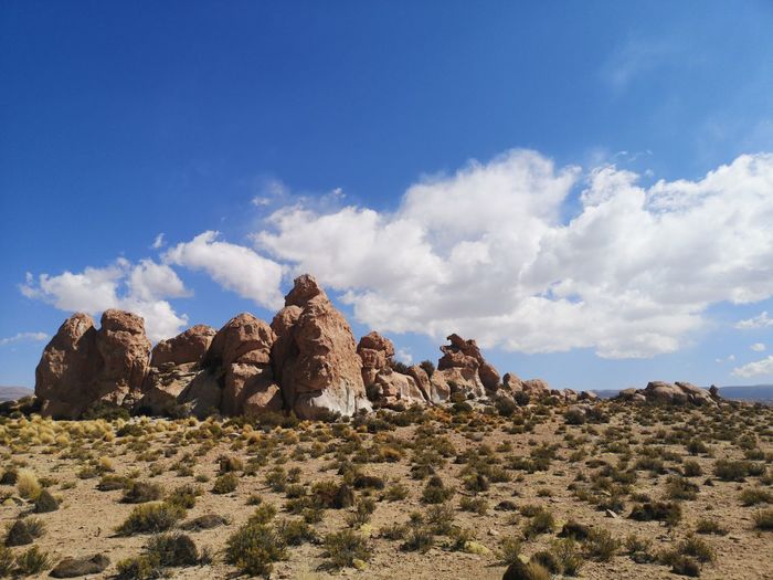Low angle view of rock formation on landscape against sky