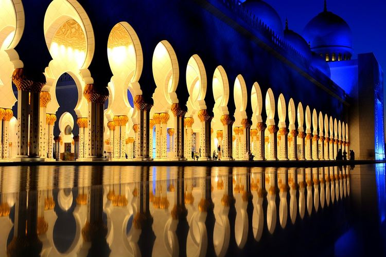 Reflection of illuminated building in water